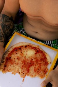 Kaboompics - Close-Up of Pizza and Tattooed Arm at the Beach