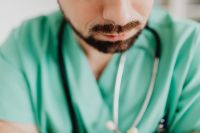 Kaboompics - Close-Up of Doctor Leaning Over Desk