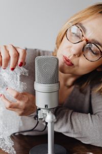 Kaboompics - Woman Whispering beside Bubble Wrap and Microphone for ASMR Sound Recording