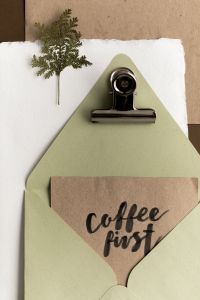Kaboompics - Green Envelope with Coffee First Handwritten Card