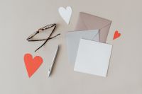 Kaboompics - Blank Stationery Mockup with Glasses, Silver Pen and Coral Paper Hearts
