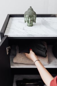 Kaboompics - Woman putting clothes on shelf