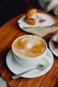 Kaboompics - Close-Up of Cappuccino Foam with a Cafe Pastry Softly Blurred Behind