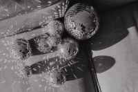Kaboompics - Low Row of Disco Balls Casting Shadows Across Sofa Cushions