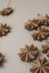 Kaboompics - Hanging Wooden Snowflake Garland on Neutral Wall