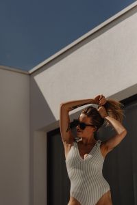 Kaboompics - Woman in Sunglasses Raising Her Arms in a Summer Swimsuit