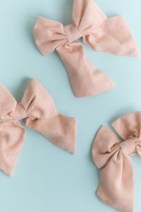Kaboompics - Multiple pastel fabric bows on light blue background flat lay