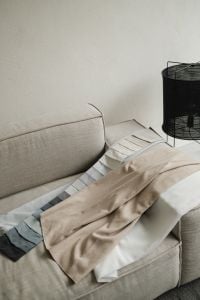 Kaboompics - Neutral Sofa with Fabric Swatches and Linen Throw