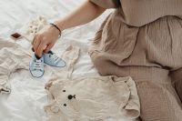 Kaboompics - Pregnant Woman Arranging Baby Clothes and Shoes
