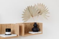 Kaboompics - Sculptural Black Vase with Dried Palms and Candle on Floating Shelf