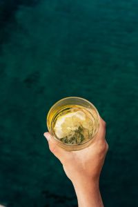Kaboompics - Hand Holding a Summer Drink beneath a Sea View