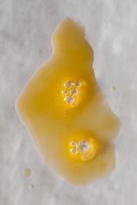 Kaboompics - Golden Skincare Gel with Air Bubbles on White Background, Macro
