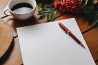 Kaboompics - Red rowan fruit with a coffee and a white sheet of paper