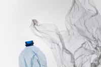 Kaboompics - Plastic Bottle And Floating Plastic Bag On White Background