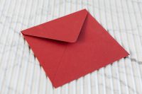 Kaboompics - Close-Up Red Paper Envelope on Ribbed Marble, Stationery Texture