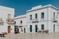 Kaboompics - Sunlit Mediterranean Square with White Buildings and Benches
