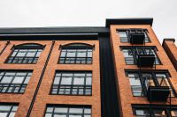 Kaboompics - Upward View of Brick Loft Facade with Black Balconies