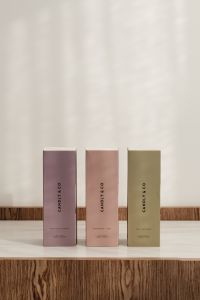 Kaboompics - Pastel Fragrance Boxes Styled on a Wood Display