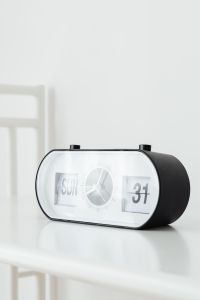 Kaboompics - Angled Black-and-White Flip Clock on White Table by a Window with Open Copy Space