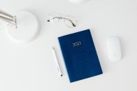 Kaboompics - Navy 2021 Planner with Eyeglasses and White Pen