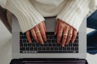 Kaboompics - Top View of Hands on a Laptop Keyboard