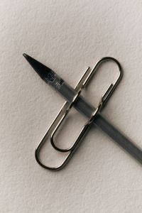 Kaboompics - Pencil and Large Paper Clip on White Background