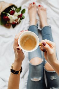 Kaboompics - Woman with coffee and flowers in bed