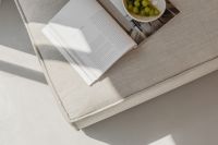 Kaboompics - Overhead Magazine and Green Grapes on a Textured Linen Couch