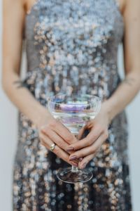 Kaboompics - Close-Up Champagne Coupe in Sharp Focus against Silver Sequins