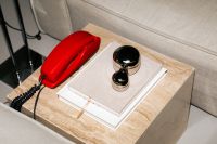 Kaboompics - Retro Red Phone And Metallic Decor On Minimal Side Table