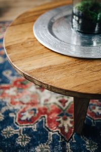 Kaboompics - Round Wooden Coffee Table with Metal Tray and Potted Plant