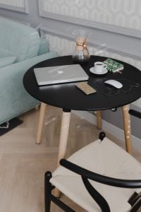 Kaboompics - Vertical Living Room Workspace with Closed Laptop, Patterned Rug, Coffee and Chemex on Black Table