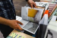 Kaboompics - A man thumbing through a book