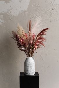 Kaboompics - Colorful Dried Flowers In White Ceramic Vase Against Textured Wall