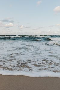 Kaboompics - Vertical Baltic Sea Waves and Foamy Surf Reaching the Sandy Shore