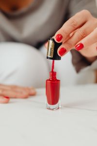 Kaboompics - Red Nail Polish Bottle and Brush for Beauty Product and Manicure Content