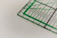 Kaboompics - Green Quilting Ruler on Graph Paper