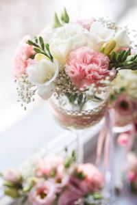Kaboompics - Pastel Pink Carnations and White Tulips in a Decorative Vase by a Bright Window