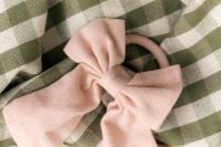 Kaboompics - Close Up Of Pastel Fabric Bow On Green Gingham Textile
