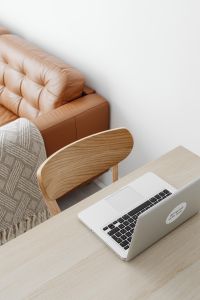 Kaboompics - Laptop and Leather Sofa Viewed from Above, Warm Neutral Home Office Background