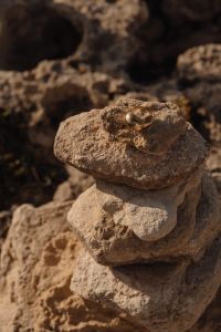 Kaboompics - Gold Ring Resting on a Coastal Stone Stack