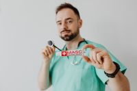 Kaboompics - Doctor Holding Ointment Tube and Stethoscope