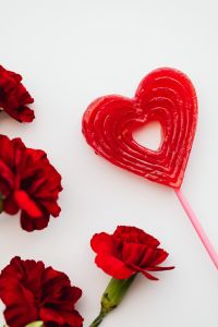 Kaboompics - Red Heart Lollipop Surrounded by Carnations