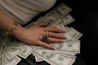 Kaboompics - Woman Resting Her Hand on Cash Wealth Mindset Aesthetic