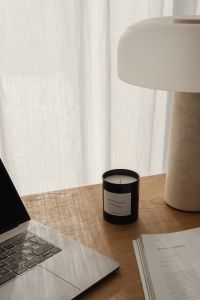 Kaboompics - Sculptural Travertine Lamp with Candle on a Wooden Desk
