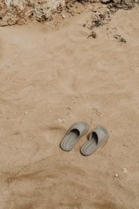 Kaboompics - Neutral Slide Sandals Cropped on Fine Beach Sand