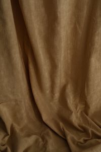 Kaboompics - Softly Draped Brown Curtain with Long Vertical Folds and Warm Texture