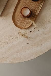 Kaboompics - Amber Glass Candle on a Wooden Tray with Dried Flowers, Travertine Background