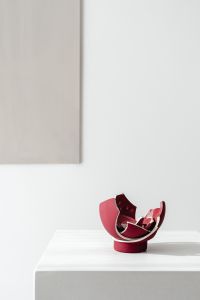 Kaboompics - Broken Rose Pink Ceramic Sculpture Against Minimal White Wall