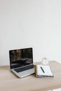 Kaboompics - Laptop and Notebook with Pen and Glass of Water on Wooden Desk